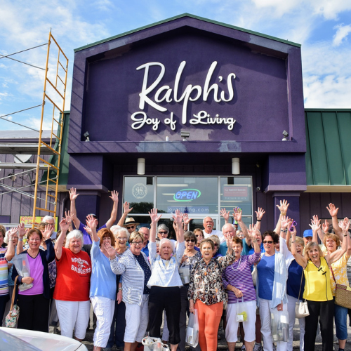 bus tour group in front of Ralphs joy of living